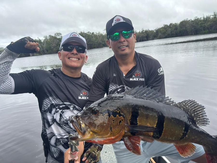 Two anglers holding a trophy catch together