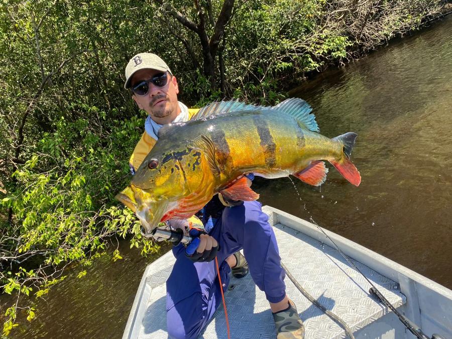Trophy catch with the flooded forest behind