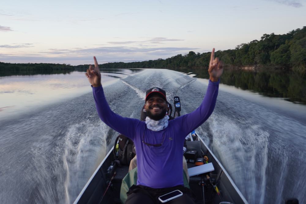 Celebrating on the bow during a sunrise boat run